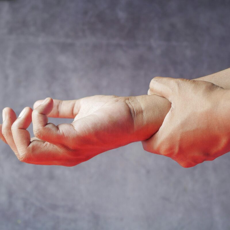 Person holding wrist from Neuropathy