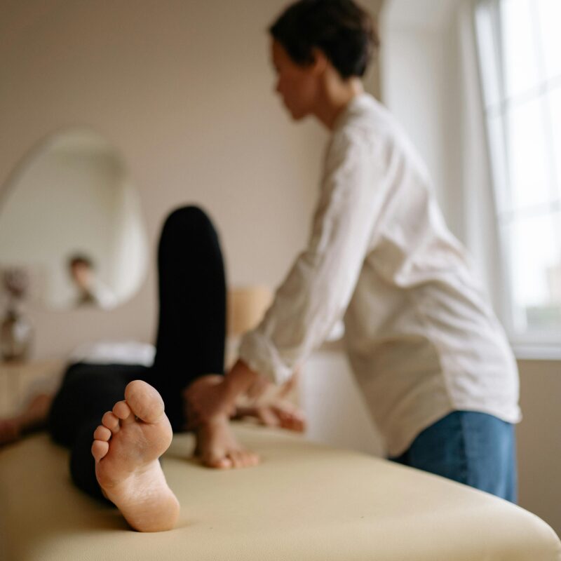 Chiropractor helping person with knee pain