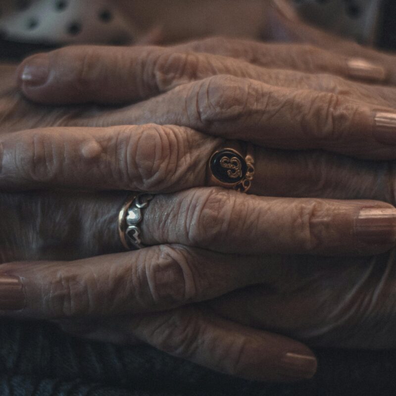 Person clasping hands with arthritis